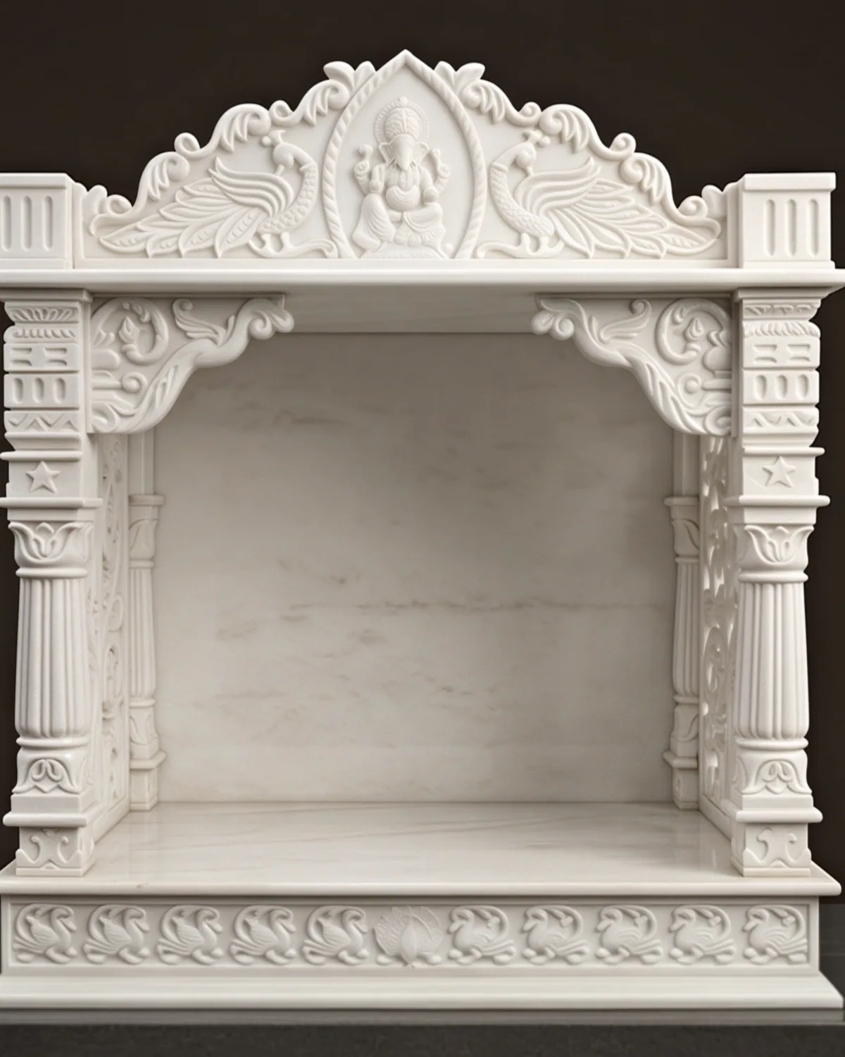Hand-carved white marble mandir with a Ganesh crest, peacocks and fluted columns