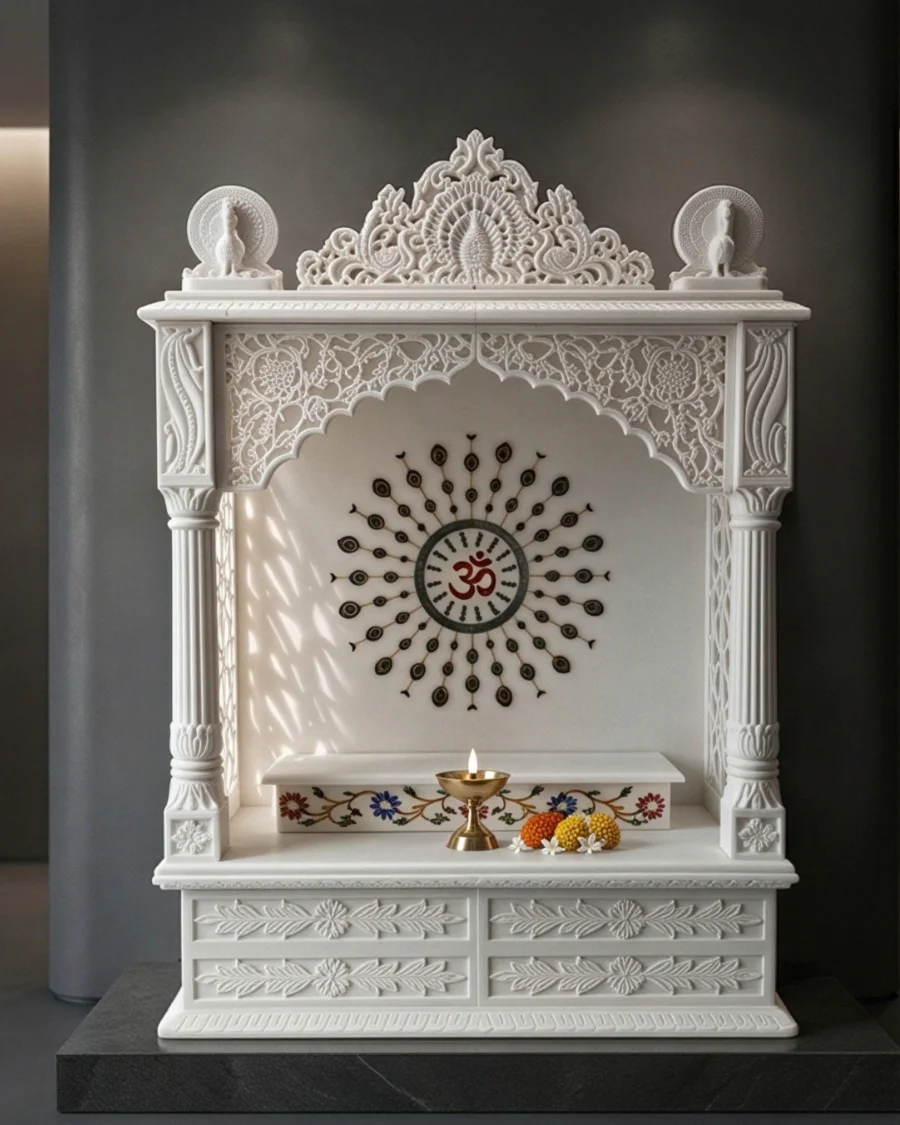 White marble mandir with a pierced Surya halo around an Om inlay and floral pietra dura step